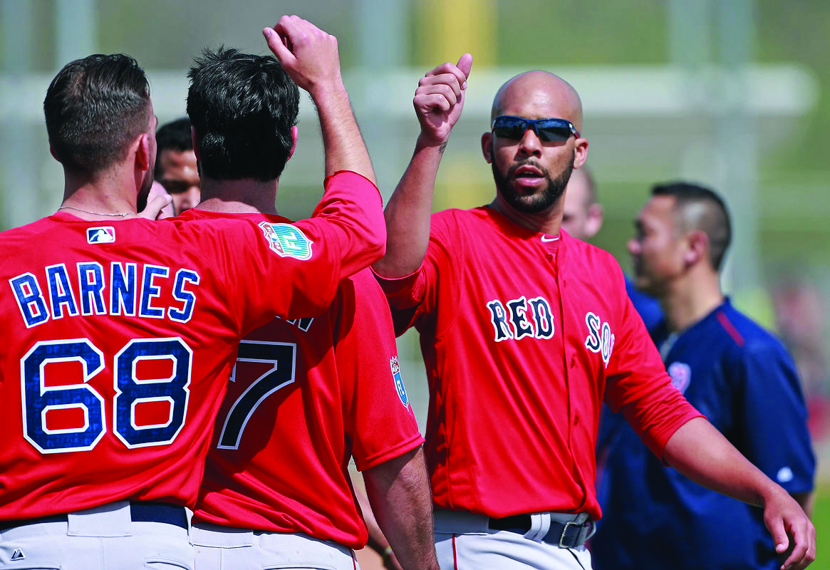 (Fort Myers , FL, 02/19/16) Boston Red Sox relief pitcher Matt Barnes bumps fists with starting pitcher David Price after running during Spring Training at JetBlue Park on Friday, February 19, 2016. Staff photo by Matt Stone